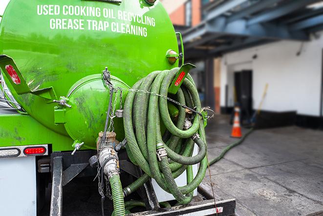 grease trap pumping truck servicing a restaurant in Amherst, MA